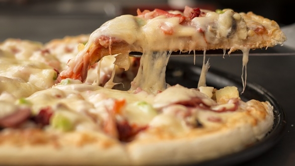 Närbild på en pizza med mycket ost.